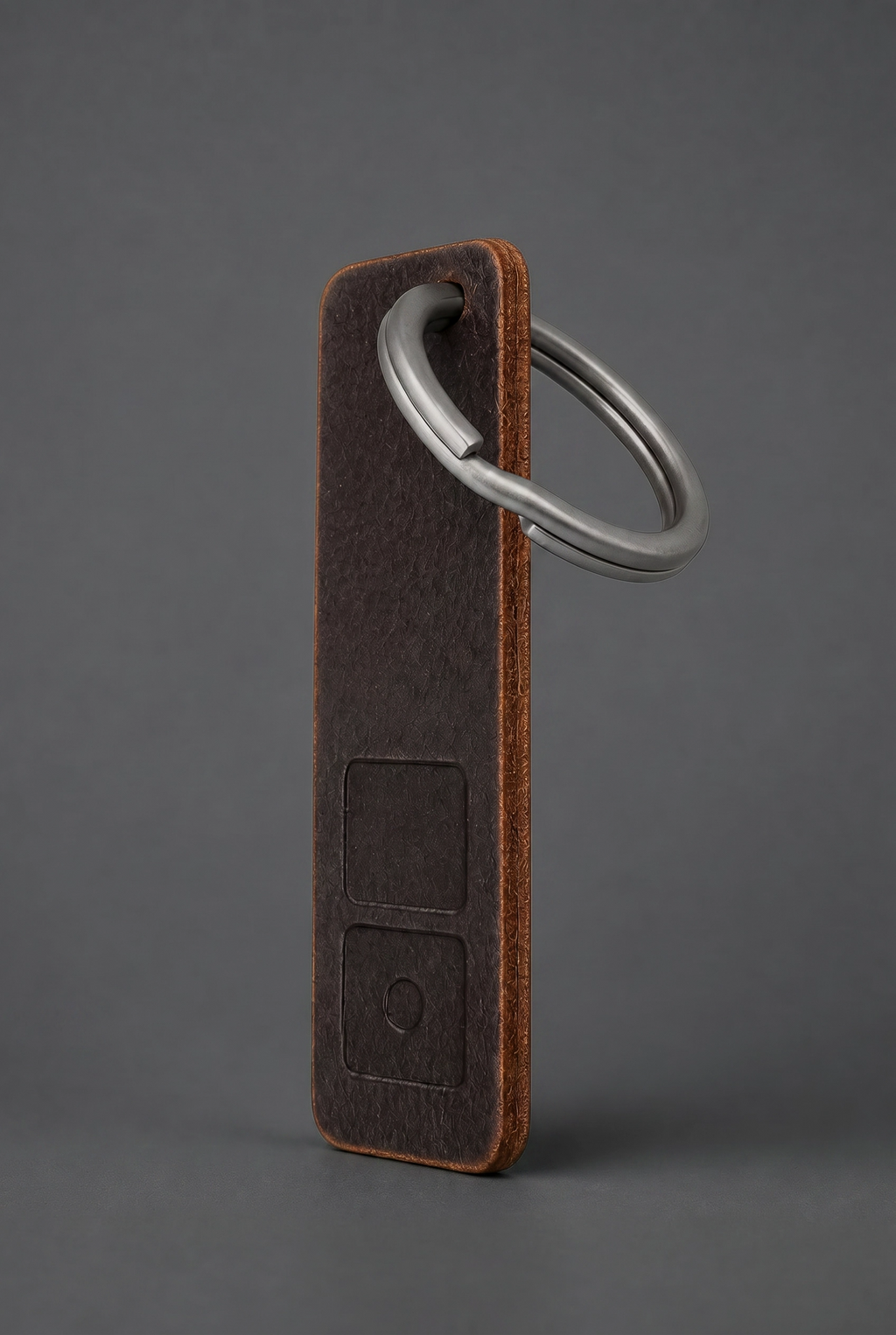 ZERONE leather and titanium key fob – view on dark grey background