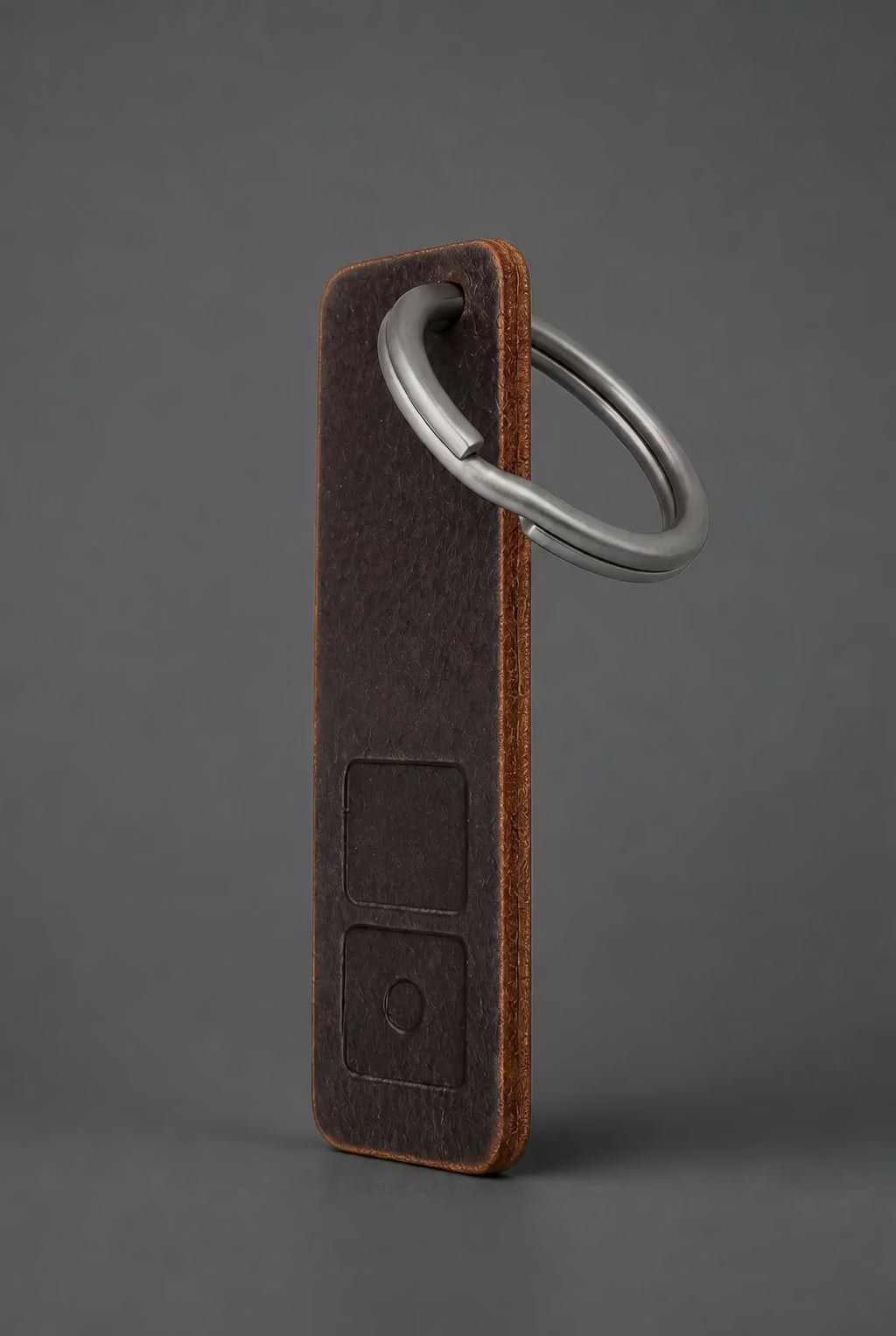 ZERONE leather and titanium key fob – view on dark grey background