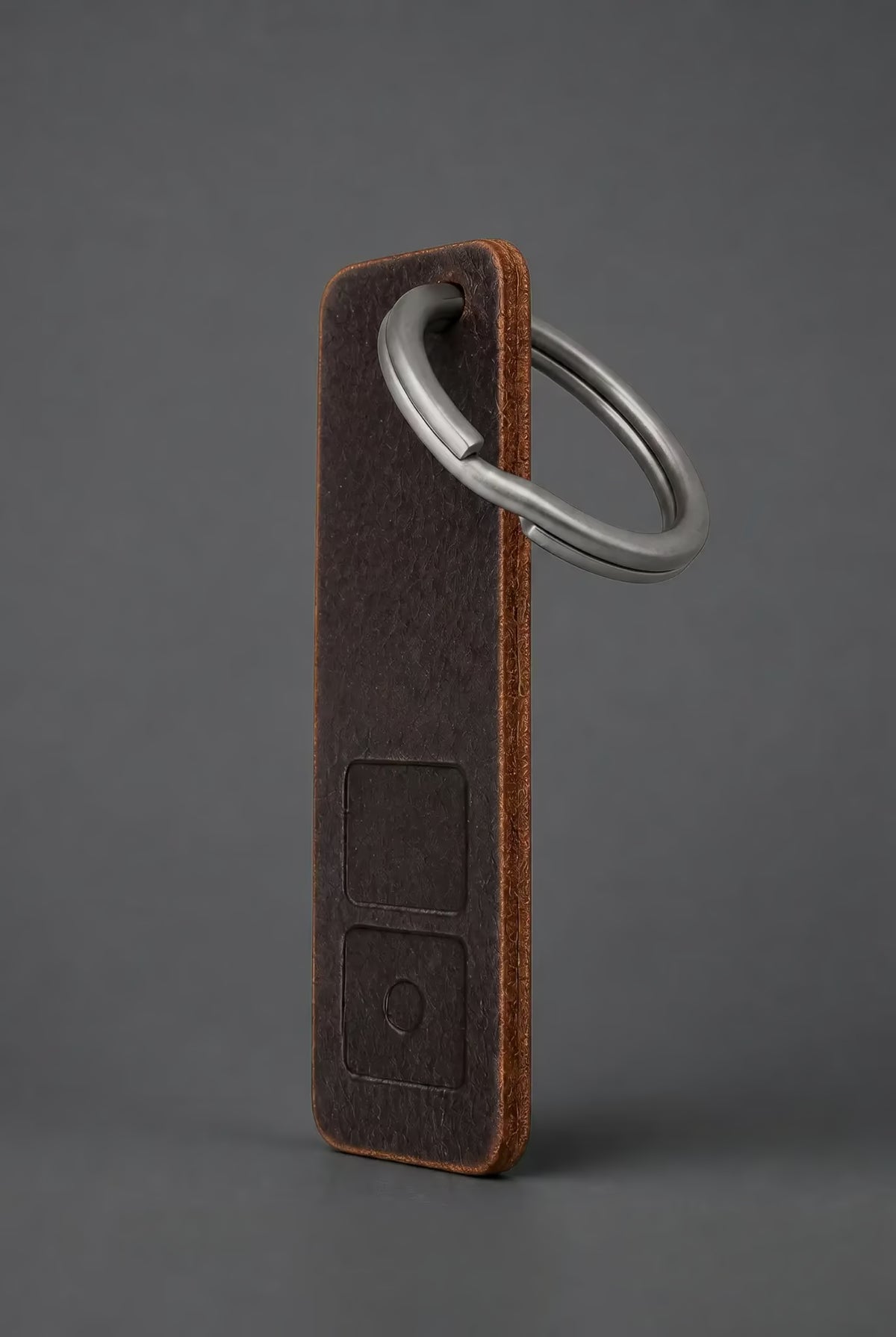 ZERONE leather and titanium key fob – view on dark grey background
